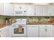Bright kitchen with granite countertops and white cabinets at 3300 Loveland Blvd # 1301, Punta Gorda, FL 33980