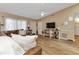 Living room with hardwood floors, brown leather couch, and built-in shelving at 3300 Loveland Blvd # 1301, Punta Gorda, FL 33980