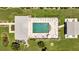 Overhead view of community pool, lounge chairs, and patio at 3300 Loveland Blvd # 1301, Punta Gorda, FL 33980