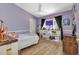 Purple bedroom with wood flooring and built-in shelving at 3300 Loveland Blvd # 1301, Punta Gorda, FL 33980