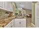 Kitchen with granite countertops and white cabinets at 3300 Loveland Blvd # 1301, Punta Gorda, FL 33980