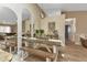 Bright dining area with a wooden table, benches, and arched mirrors at 3300 Loveland Blvd # 1301, Punta Gorda, FL 33980