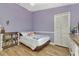 Purple bedroom with wood flooring and bookshelves at 3300 Loveland Blvd # 1301, Punta Gorda, FL 33980