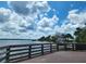 Wooden boardwalk offering scenic water views and access to a sandy area at 1286 Hillcrest Nw Ave, Port Charlotte, FL 33948