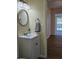 Clean bathroom with updated vanity and round mirror at 1286 Hillcrest Nw Ave, Port Charlotte, FL 33948
