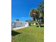 Spacious backyard with lush grass and two palm trees at 1286 Hillcrest Nw Ave, Port Charlotte, FL 33948