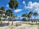 Relaxing beach view with palm trees, bench, and calm water at 1286 Hillcrest Nw Ave, Port Charlotte, FL 33948