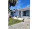 White single story home with gray door and landscaping at 1286 Hillcrest Nw Ave, Port Charlotte, FL 33948