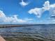 Long pier extending into the water under a bright sky at 1286 Hillcrest Nw Ave, Port Charlotte, FL 33948
