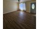 Spacious living room with wood-look floors and ample natural light at 1286 Hillcrest Nw Ave, Port Charlotte, FL 33948