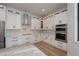 Modern kitchen with white cabinets, stainless steel appliances, and granite countertops at 17594 Vellum Cir, Punta Gorda, FL 33955