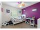 Bedroom with a twin bed and purple accent wall at 265 Tipton St, Port Charlotte, FL 33954