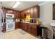 Kitchen with wood cabinets, granite counters, and white appliances at 265 Tipton St, Port Charlotte, FL 33954