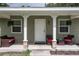 Inviting front porch with seating and hanging plants at 265 Tipton St, Port Charlotte, FL 33954