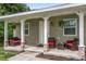 Covered porch with seating and landscaping at 265 Tipton St, Port Charlotte, FL 33954
