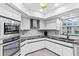 Modern kitchen with stainless steel appliances and granite countertops at 5001 Richmond Ter, North Port, FL 34287