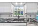 Kitchen sink with black faucet and granite countertop at 5001 Richmond Ter, North Port, FL 34287