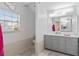 Clean bathroom with gray vanity, toilet and shower at 5001 Richmond Ter, North Port, FL 34287