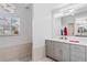 Modern bathroom with gray vanity and double sinks at 5001 Richmond Ter, North Port, FL 34287
