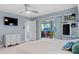 King bedroom with private patio access and large TV at 5001 Richmond Ter, North Port, FL 34287