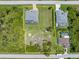 Aerial view showing a single-Gathering home with a pool and large backyard at 14041 Clarissa Ln, Port Charlotte, FL 33981
