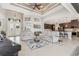 Bright living area featuring tile floors, two sofas, and access to kitchen at 14041 Clarissa Ln, Port Charlotte, FL 33981