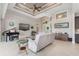 Spacious living room showcasing tile floors, sofas, and a grand piano at 14041 Clarissa Ln, Port Charlotte, FL 33981