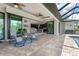Covered patio with seating and view into the living room at 14041 Clarissa Ln, Port Charlotte, FL 33981