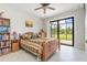 Bedroom with a wooden bed, large window, and access to a private patio at 14041 Clarissa Ln, Port Charlotte, FL 33981