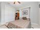 Guest bedroom with a wall bed, window with plantation shutters, and built-in shelving at 14041 Clarissa Ln, Port Charlotte, FL 33981