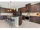 Elegant kitchen boasting dark wood cabinets, granite island, and stainless steel appliances at 14041 Clarissa Ln, Port Charlotte, FL 33981