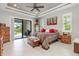 Main bedroom with king-size bed and access to the pool at 14041 Clarissa Ln, Port Charlotte, FL 33981