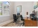 Home office with two desks, window with plantation shutters, and ample natural light at 14041 Clarissa Ln, Port Charlotte, FL 33981