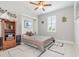 Guest bedroom with a wall bed, window with plantation shutters, and built-in shelving at 14041 Clarissa Ln, Port Charlotte, FL 33981