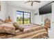Spacious bedroom with a comfortable bed, large window, and sliding door to backyard at 14041 Clarissa Ln, Port Charlotte, FL 33981