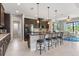 Modern kitchen with dark cabinetry, granite counters, and stainless steel appliances at 14041 Clarissa Ln, Port Charlotte, FL 33981