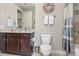 Bathroom with granite vanity, dark wood cabinets, and shower at 14041 Clarissa Ln, Port Charlotte, FL 33981