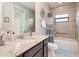 Bathroom with granite countertop vanity, shower/tub combo, and decorative accents at 14041 Clarissa Ln, Port Charlotte, FL 33981