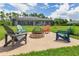 Relaxing backyard firepit area with comfortable seating and a spacious lawn at 14041 Clarissa Ln, Port Charlotte, FL 33981