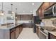 Stylish kitchen featuring dark cabinetry, granite countertops, and a large island at 14041 Clarissa Ln, Port Charlotte, FL 33981