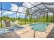 Covered patio and pool with seating and backyard view at 14041 Clarissa Ln, Port Charlotte, FL 33981