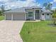 Single-Gathering home with three-car garage and attractive landscaping at 14041 Clarissa Ln, Port Charlotte, FL 33981