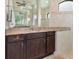 Bathroom with granite countertops and dark wood cabinets at 14041 Clarissa Ln, Port Charlotte, FL 33981