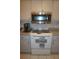 Well-equipped kitchen featuring stainless steel microwave and electric stovetop at 7100 Mineola Rd, Englewood, FL 34224