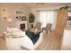 Living room with fireplace, wood-look floors, and comfy seating at 7100 Mineola Rd, Englewood, FL 34224