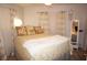 Bedroom with a queen bed, yellow bedding, and decorative pillows at 7100 Mineola Rd, Englewood, FL 34224