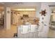 Open kitchen with island, seating and stainless steel appliances at 7100 Mineola Rd, Englewood, FL 34224