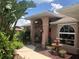 House exterior with walkway and fountain in front yard at 7100 Mineola Rd, Englewood, FL 34224