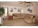 Spacious living room featuring a large sectional sofa and wood-look flooring at 7100 Mineola Rd, Englewood, FL 34224