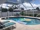 Inviting screened pool with lounge chairs and floating toys at 7100 Mineola Rd, Englewood, FL 34224